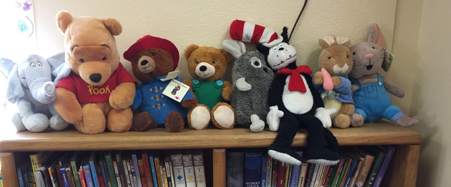 a collection of book character plushies